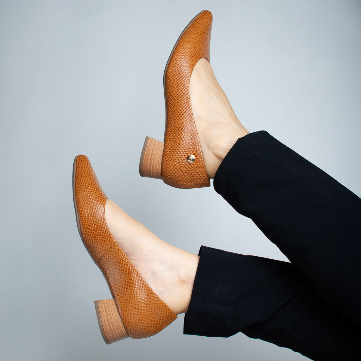 Woman wearing scale whiskey Orégano pumps with black trousers - lifestyle view