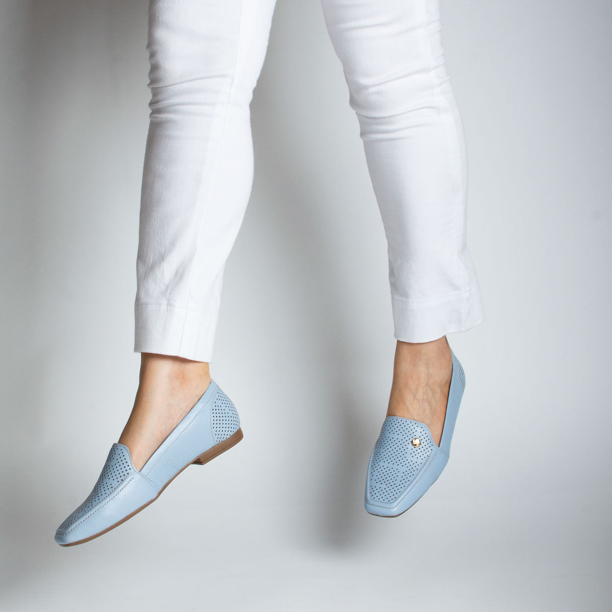 Woman wearing Goiaba loafers with white trousers - lifestyle view