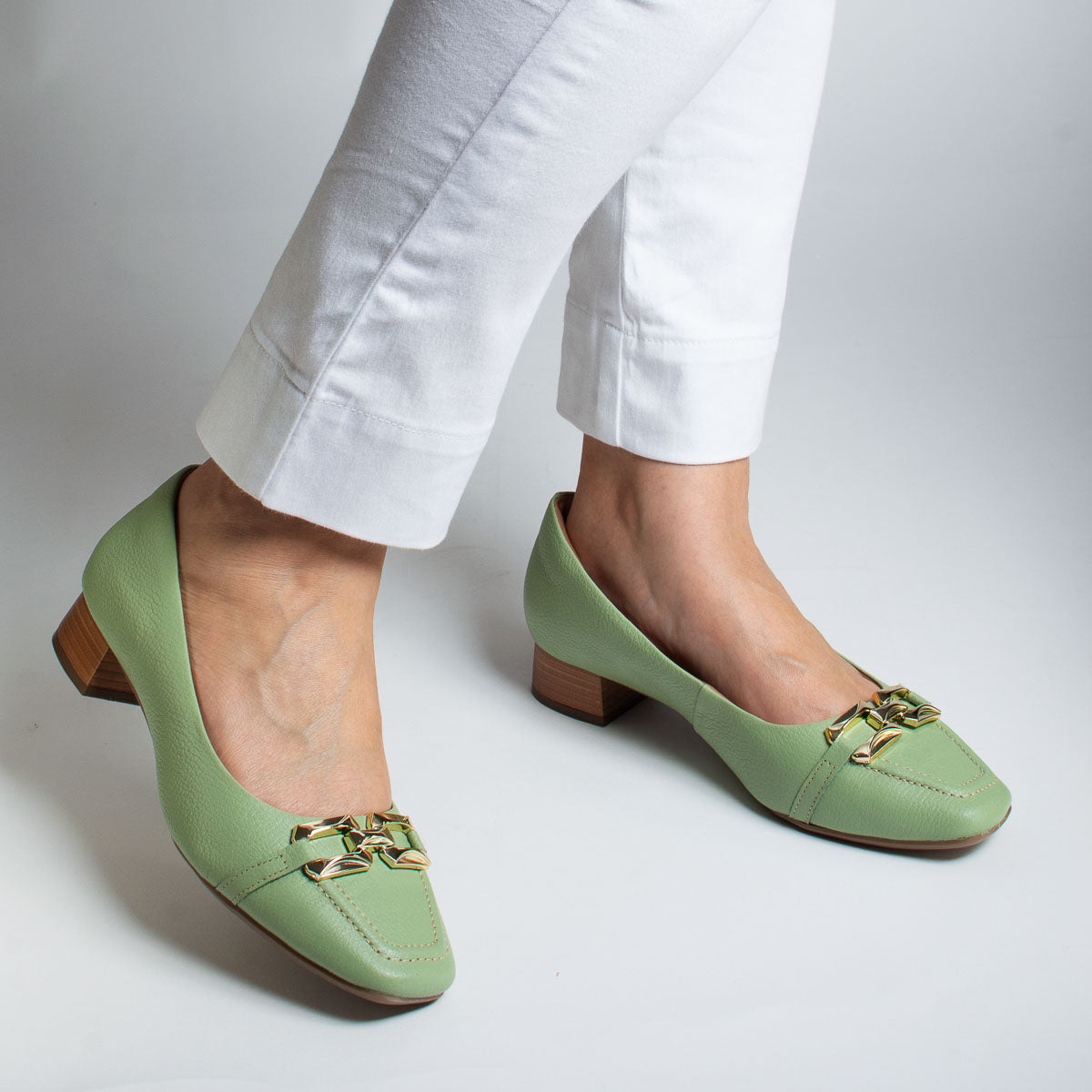 Woman wearing Manjericão pumps with grey trousers - lifestyle view