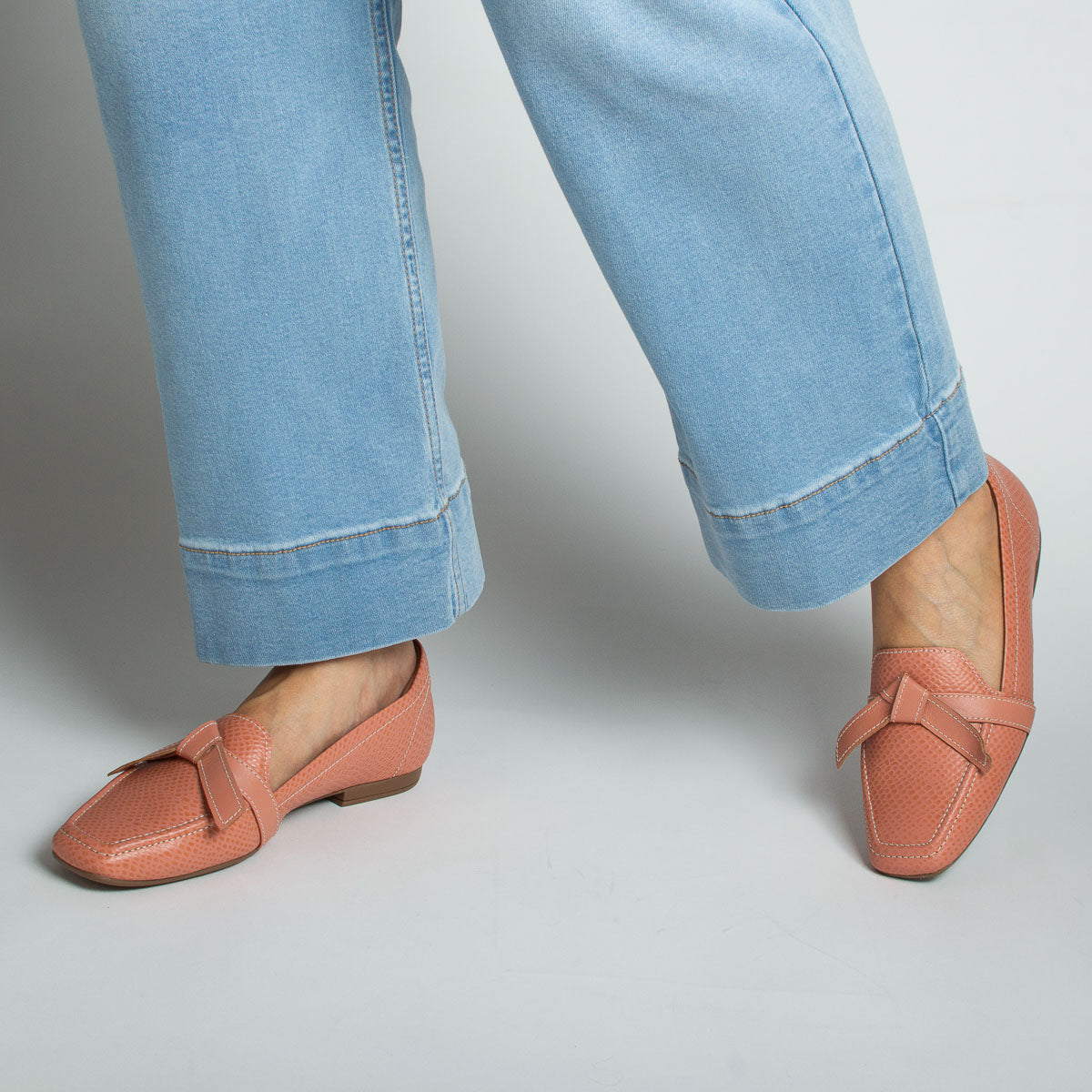 Woman wearing Caju loafers with light blue jeans - lifestyle view