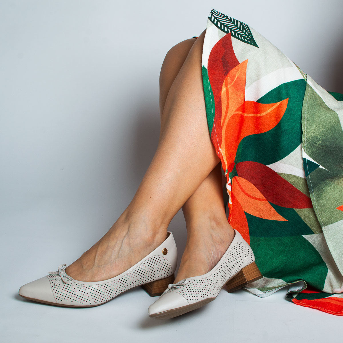 Woman wearing Alecrim pumps with colourful top - lifestyle view