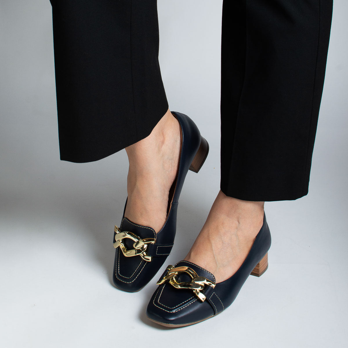 Woman wearing Coentro pumps with black trousers - lifestyle view