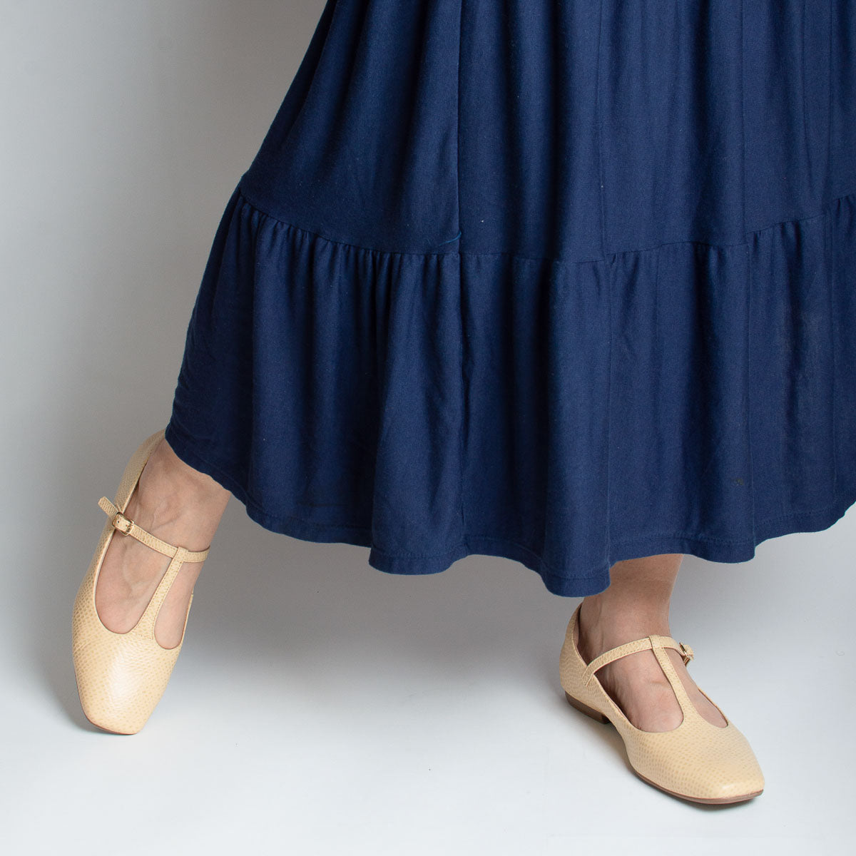 Woman wearing Jabuticaba flats with navy dress - lifestyle view