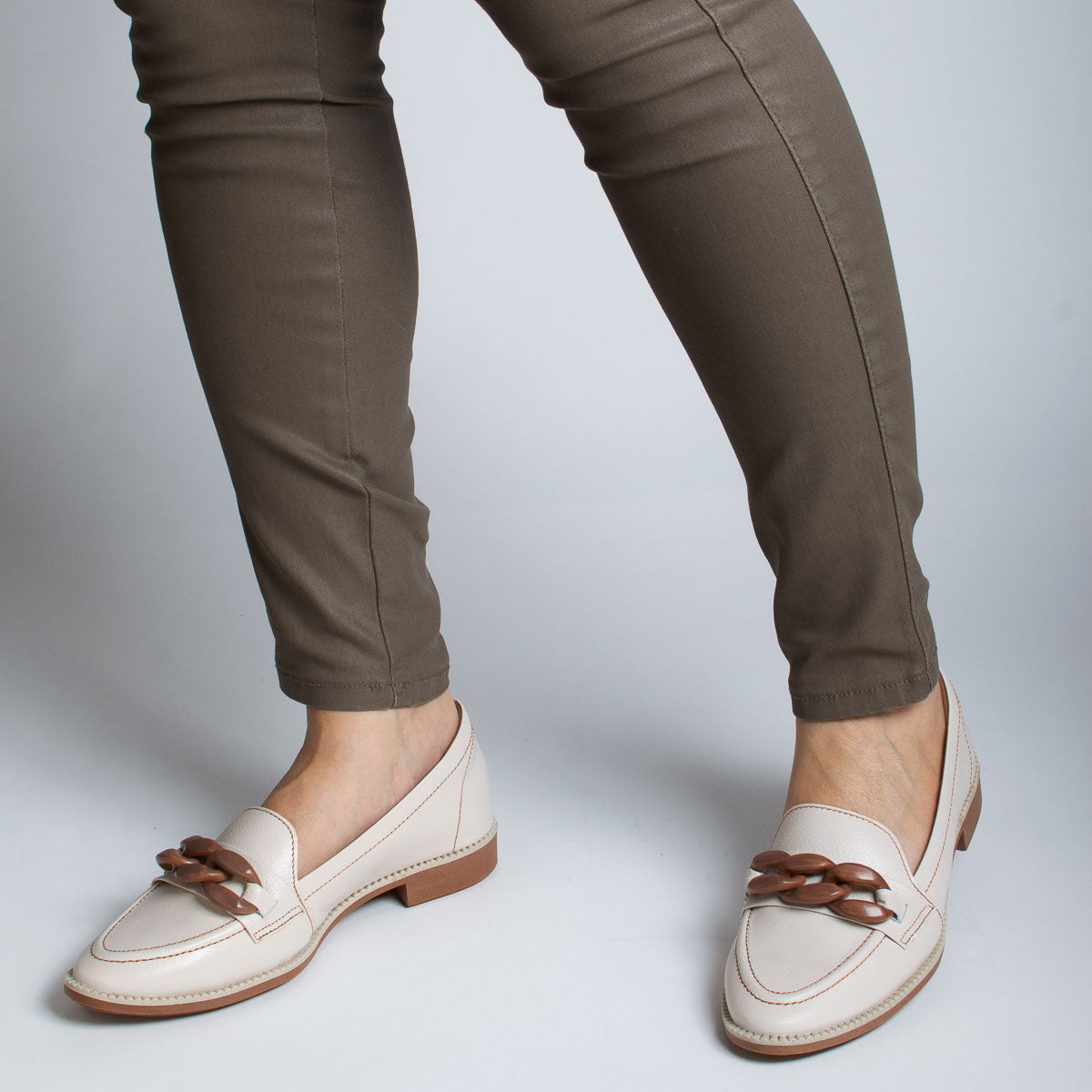 Woman wearing Pitanga loafers with grey trousers - lifestyle view