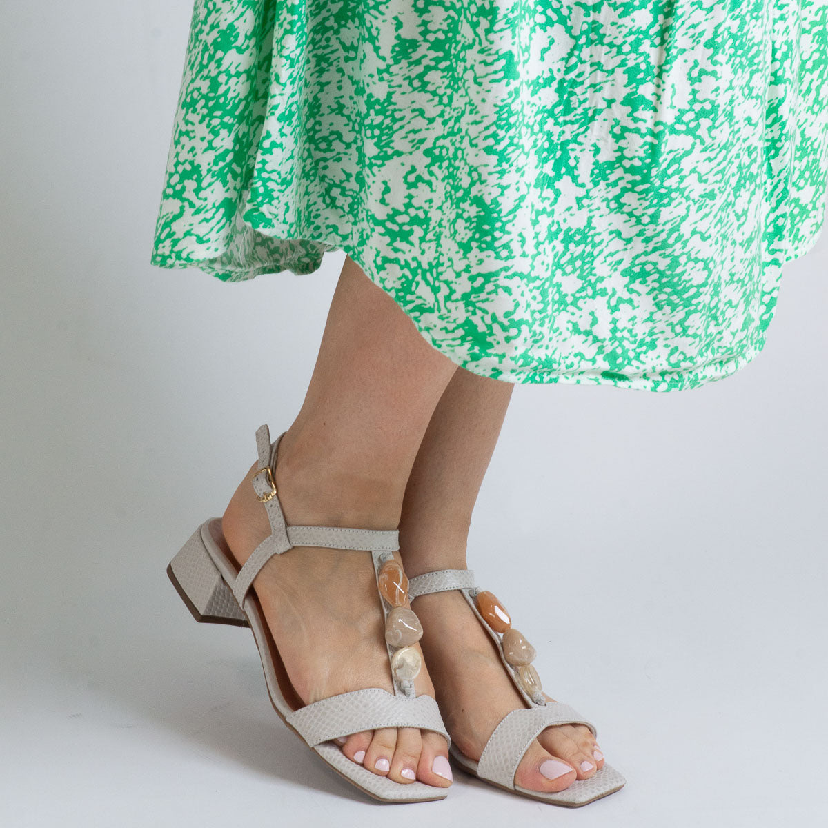 Woman wearing Violeta sandals with green floral dress - lifestyle view