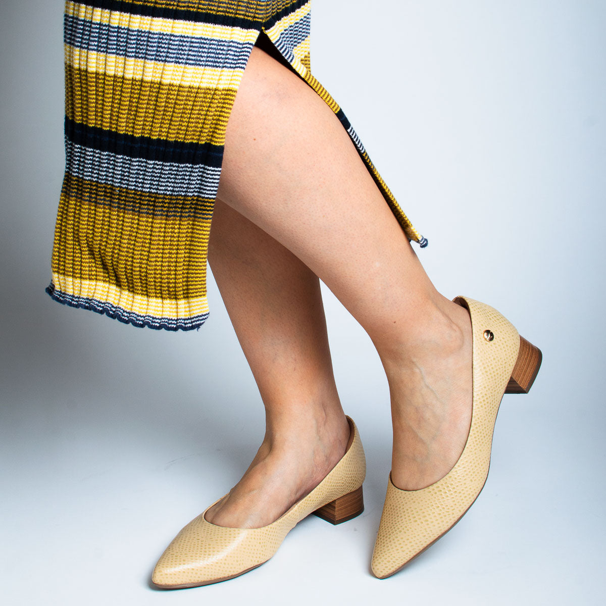Woman wearing Orégano pumps with striped top - lifestyle view
