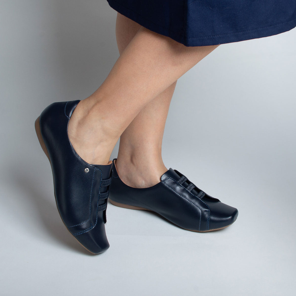 Woman wearing Pau-Brasil shoes with navy trousers - lifestyle view