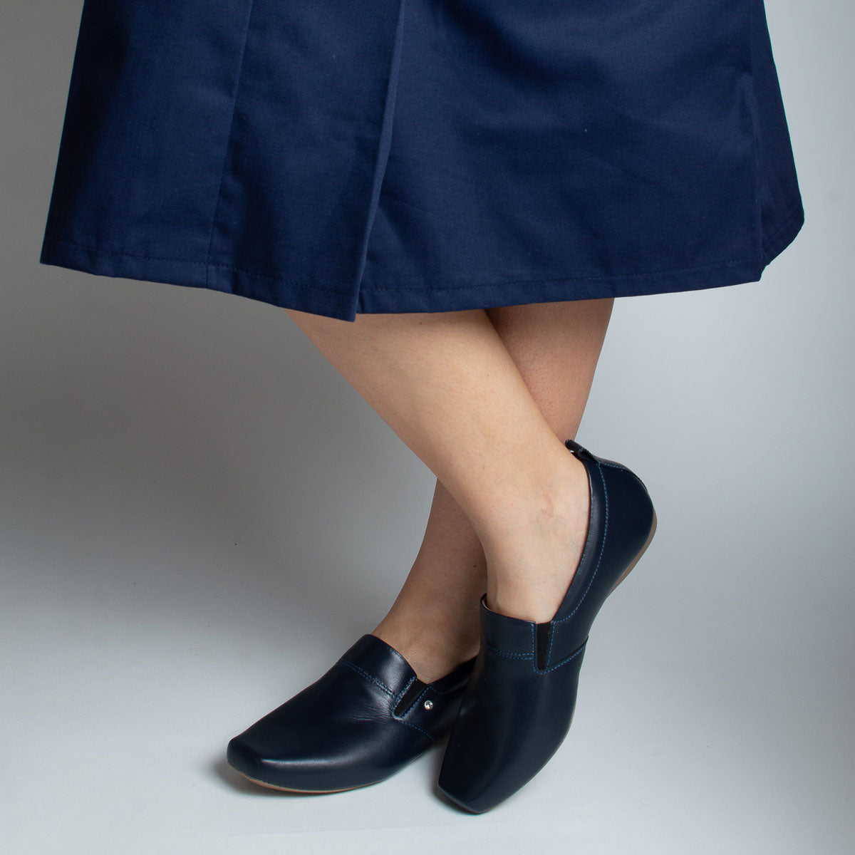 Woman wearing Jacarandá shoes with navy dress - lifestyle view
