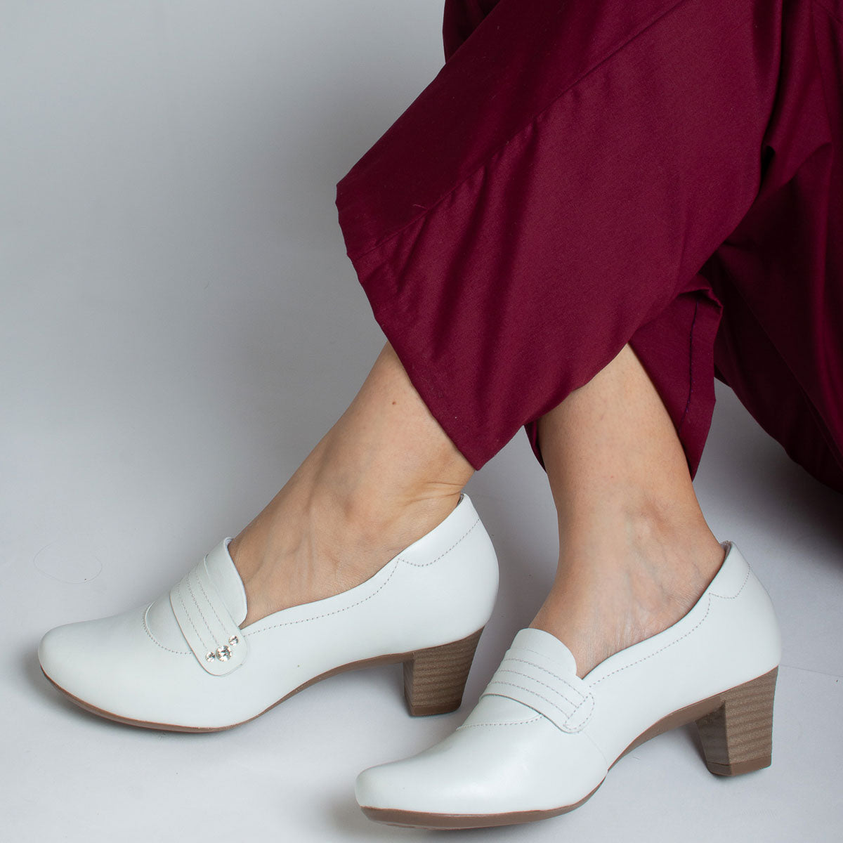 Woman wearing vegetal off-white Canela shoes with burgundy trousers - lifestyle view