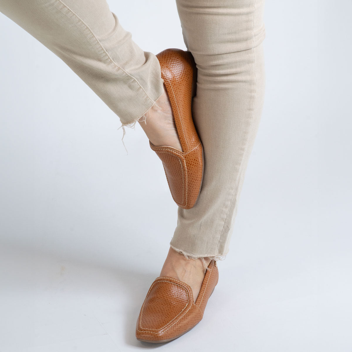 Woman wearing Graviola loafers with white trousers - lifestyle view