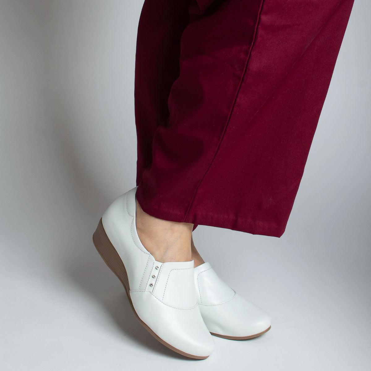 Woman wearing Castanheira shoes with burgundy trousers - lifestyle view