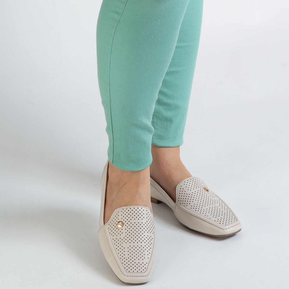 Woman wearing floater off-white Goiaba loafers with mint trousers - lifestyle view