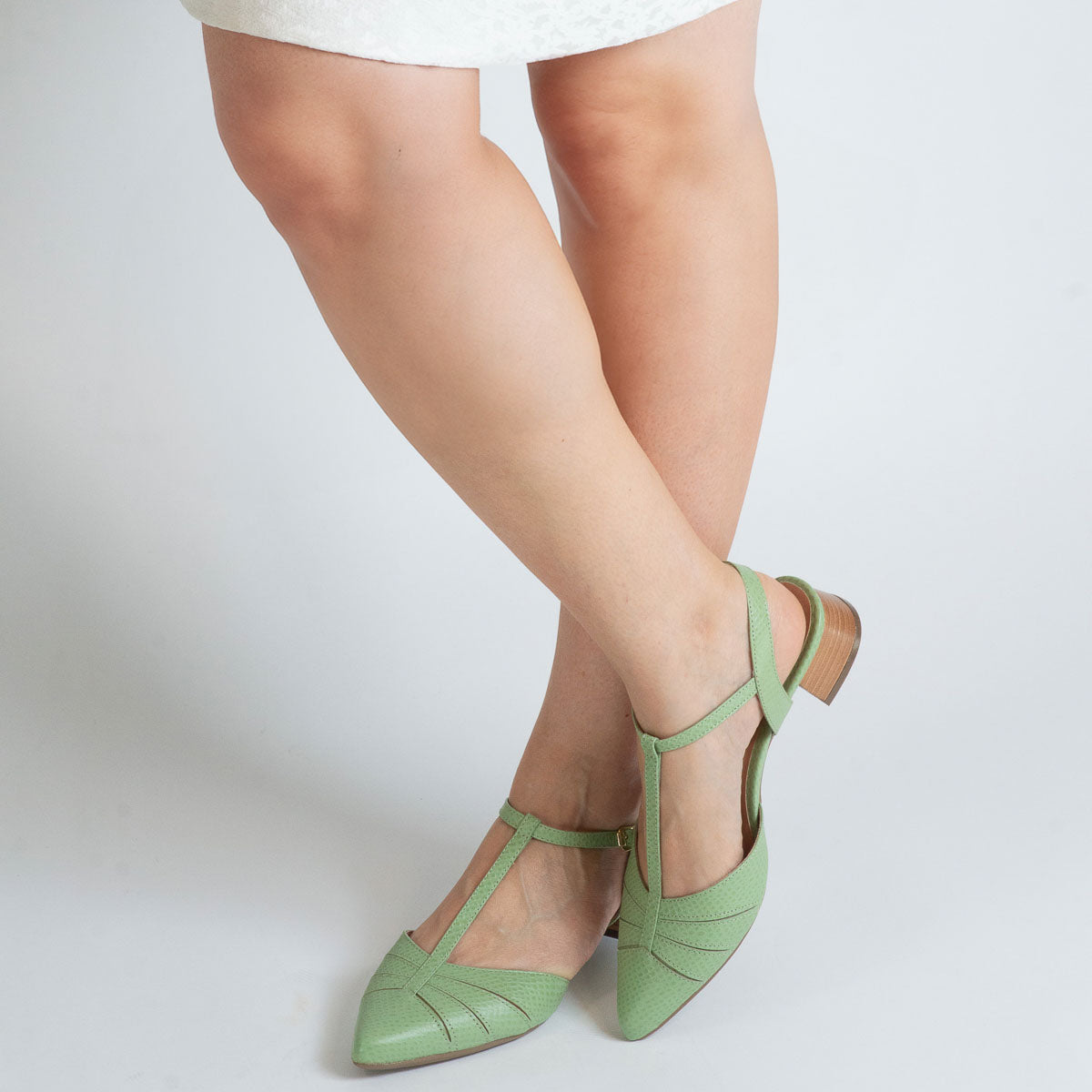 Woman wearing scale pistachio Margarida pumps - lifestyle view