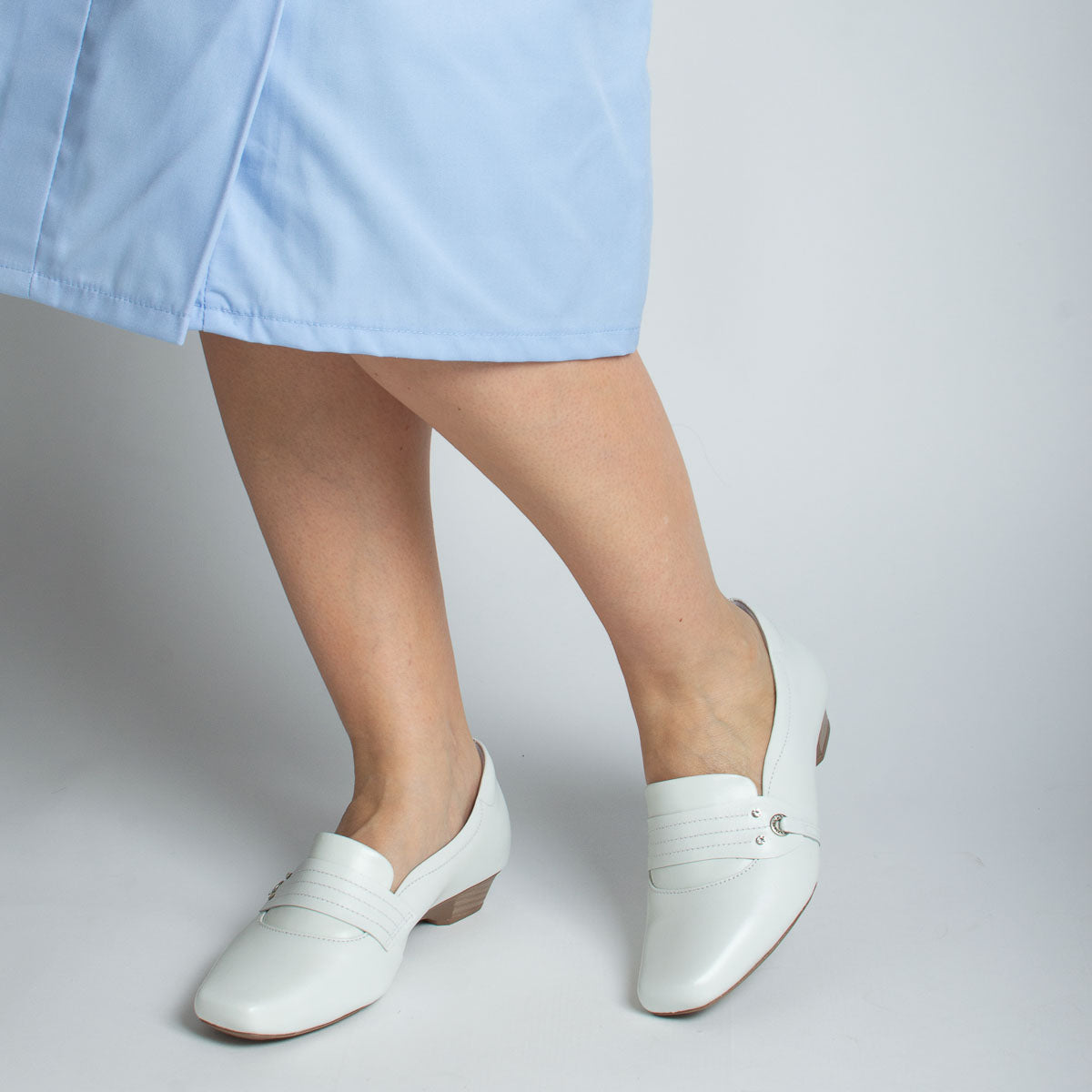 Woman wearing Imbuia shoes with light blue scrubs - lifestyle view