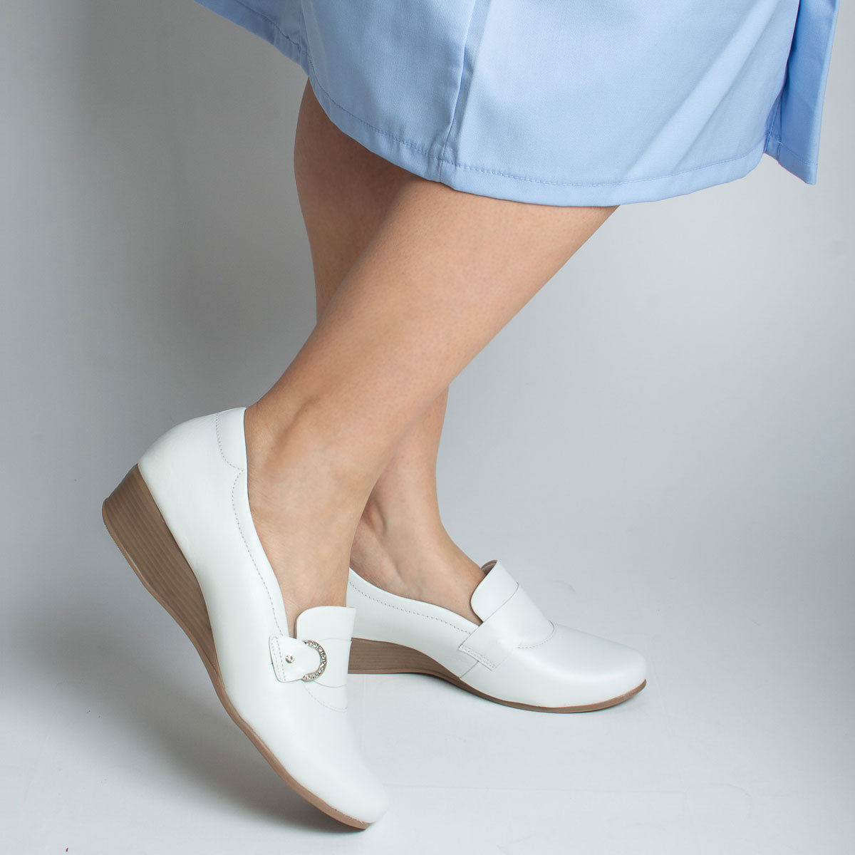 Woman wearing Seringueira shoes with light blue top - lifestyle view