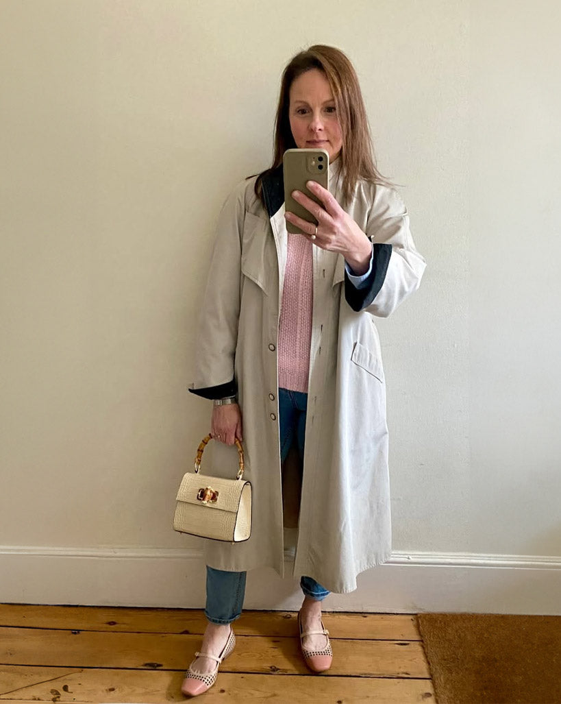 Woman wearing comfortable Terraloom shoes with beige trench coat and jeans - customer styling inspiration