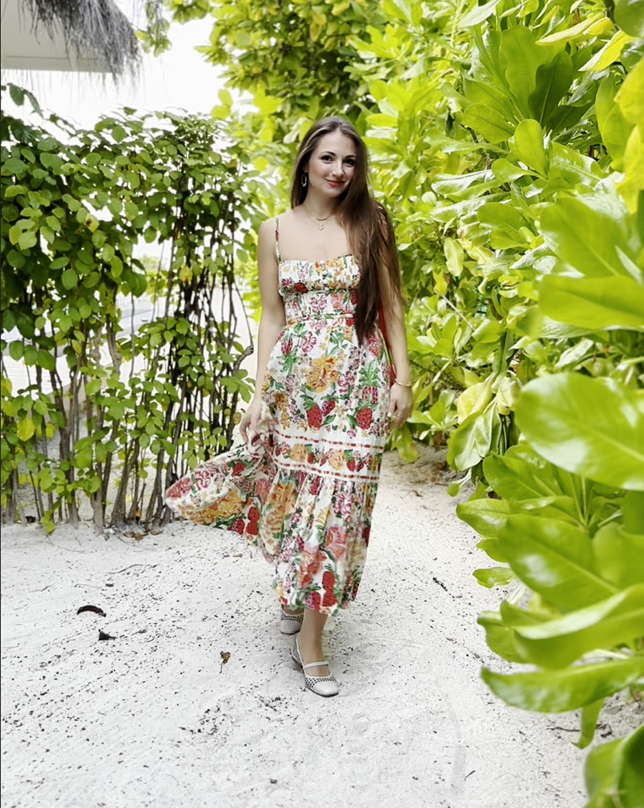 Woman wearing comfortable Terraloom shoes with floral maxi dress in tropical garden - customer styling inspiration